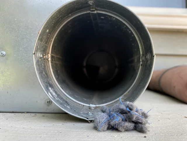 Altadena Dryer Vent Cleaning technician using specialized equipment to clear severe dryer vent blockage in Altadena